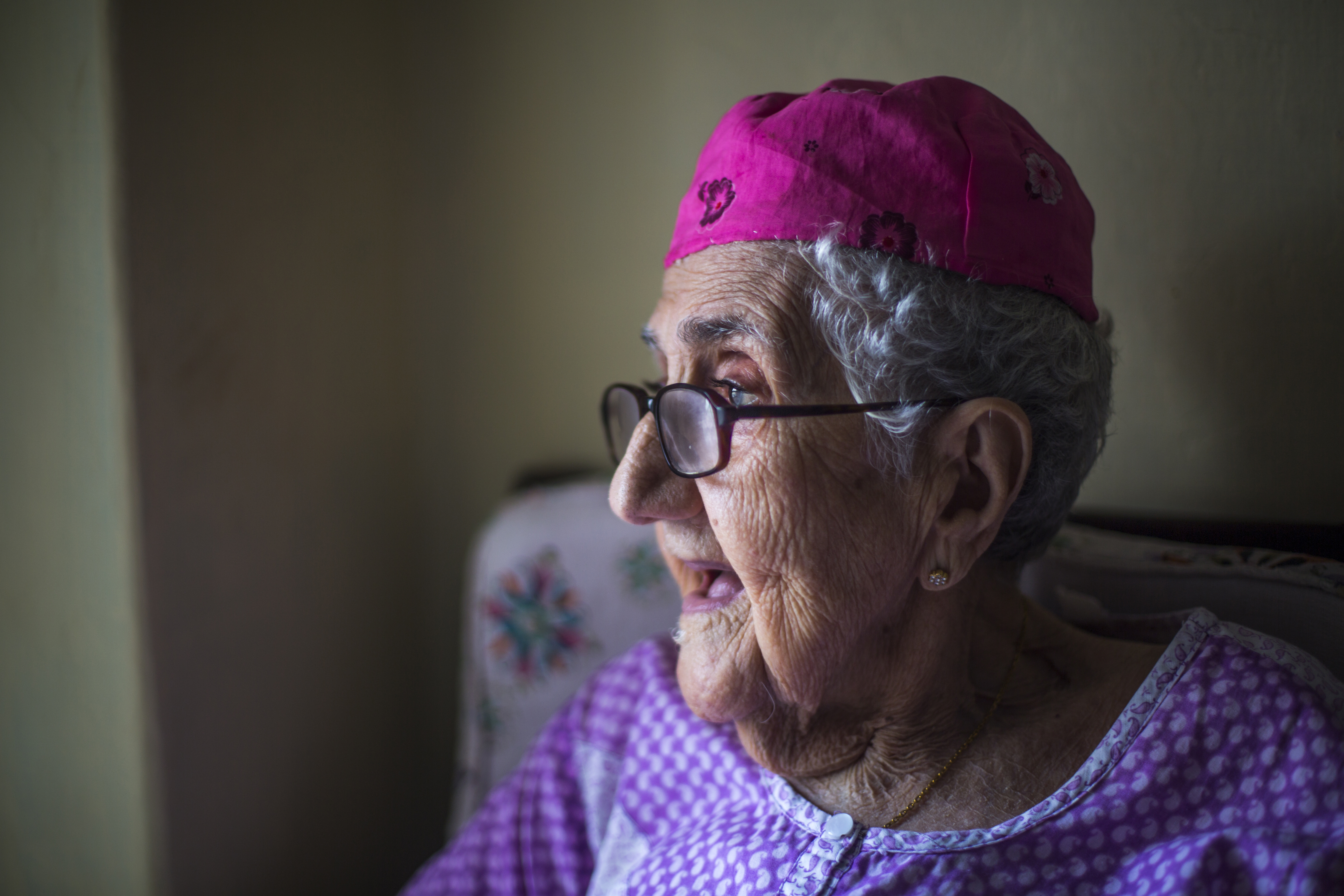 Sarah Cohen, 95, one of five remaining Paradesi Jews in Mattancherry, Cochin, in her bedroom. Every morning, she enjoys a range of Kerala and Jewish dishes (dosa, idli, challah bread) and then spends the majority of her day sitting by the window, singing prayers and people-watching.