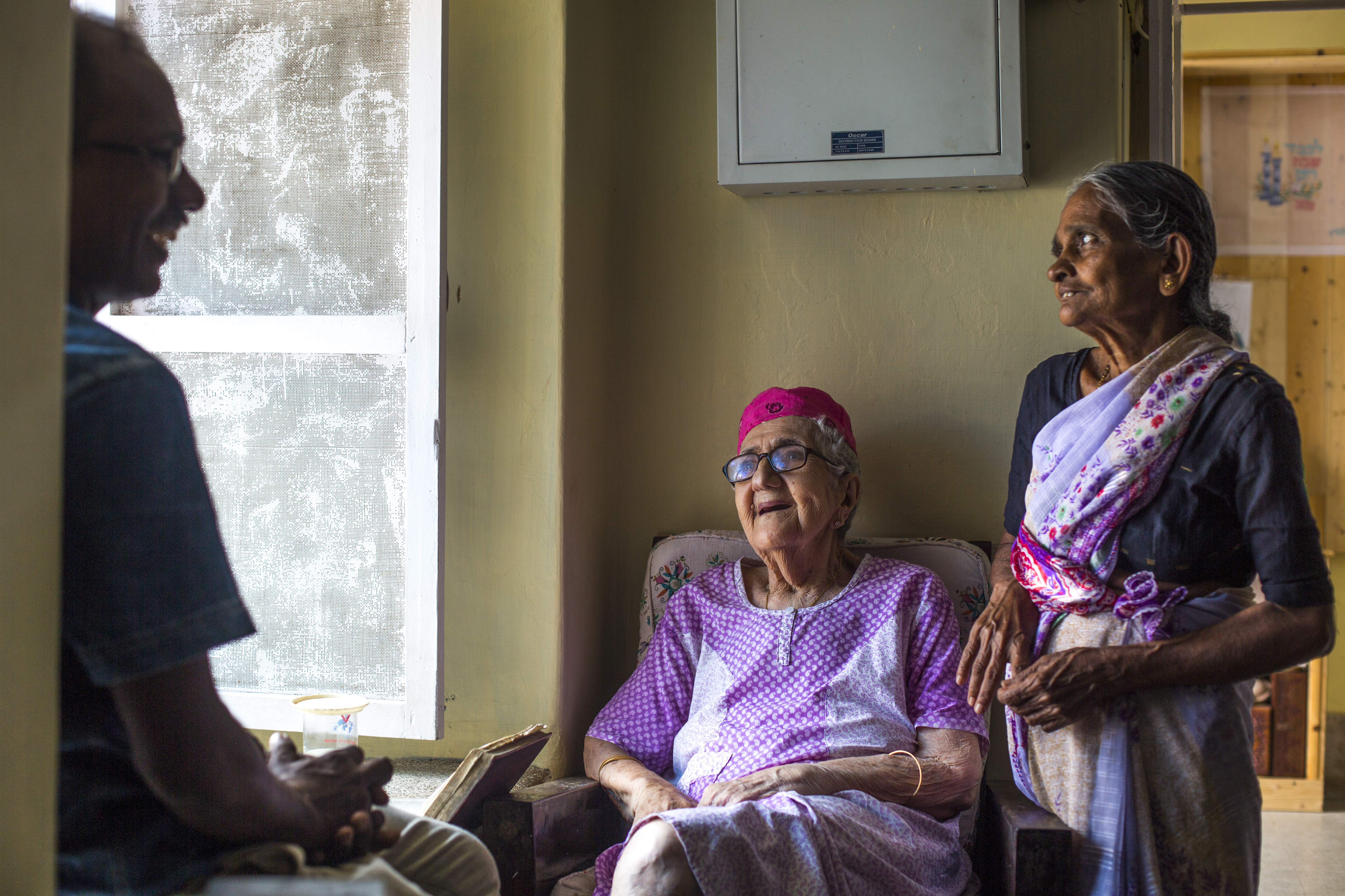 Sarah Cohen with her caretaker Thaha Ibrahim (left) and her cook Celine Xavier (right).