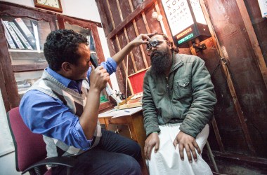 Technician Namken Lhama examines a man at the Eye Clinic in Jomsom, Mustang District, Nepal, in 2014.