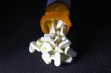 Photo showing pills spilling out of a prescription bottle