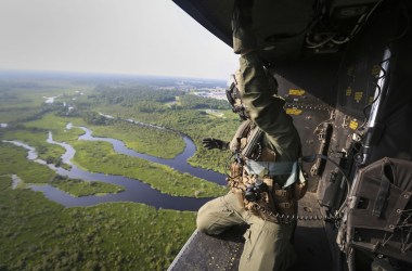 A crew chief with Marine Light Attack Helicopter Squadron 167, 2nd Marine Aircraft Wing, rides in the back of a UH-1Y Venom as it approaches a landing zone during a training exercise near Camp Lejeune, North Carolina, on June 17th, 2016.