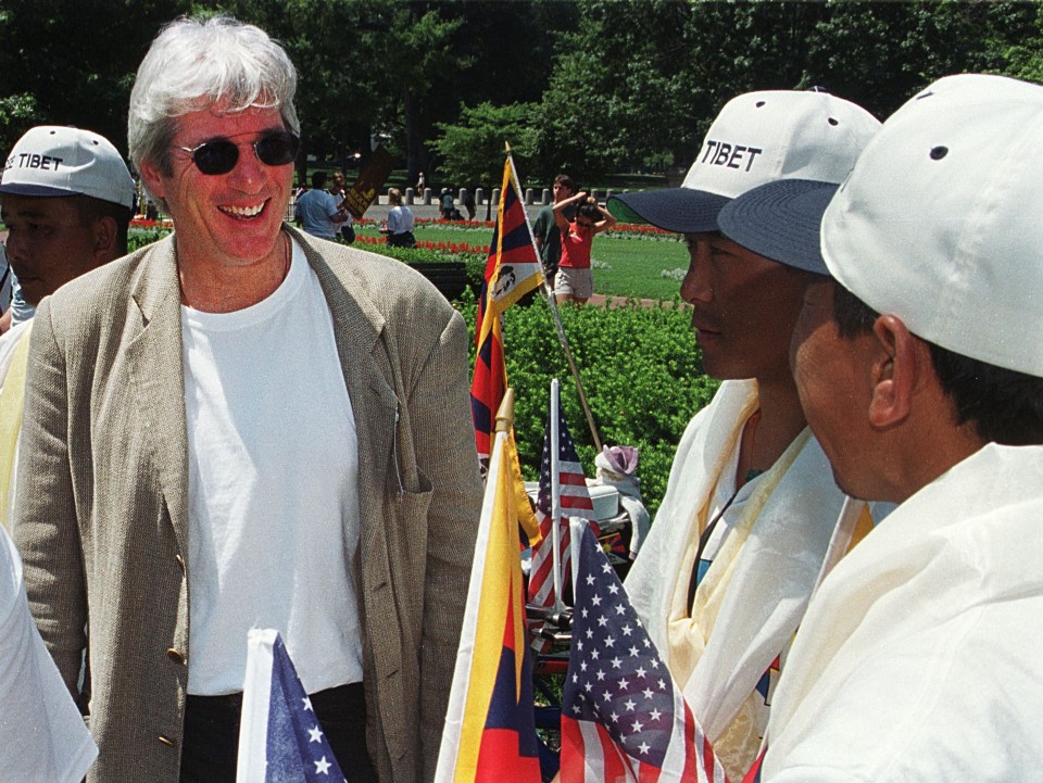 Richard Gere laughs with Tibetan protesters before giving a speech at a rally to free Tibet on July 1st, 2000.