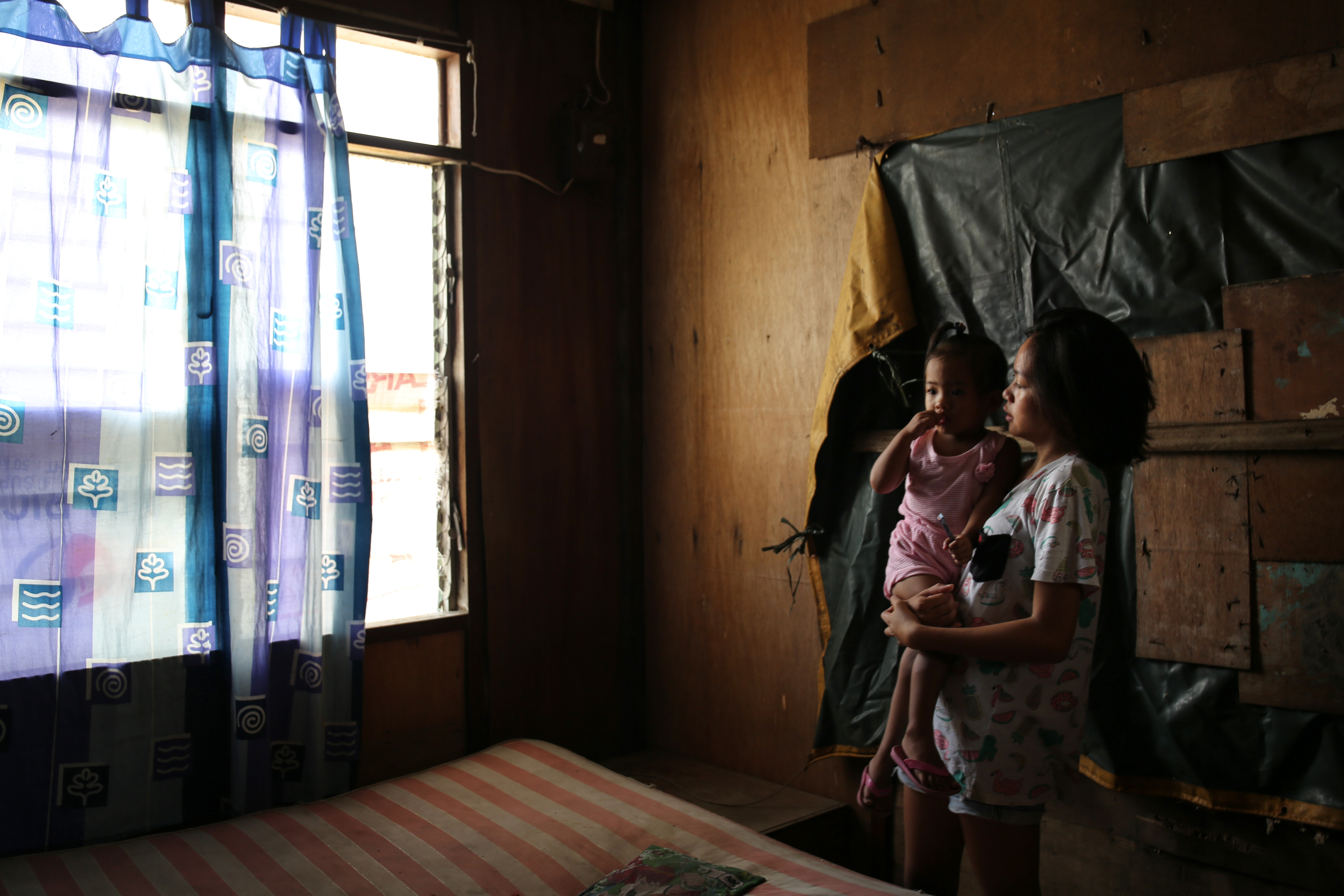 Sira Alfonso, 20, and one-year-old Carolyn Joy were in their house with seven family members when the typhoon hit. 