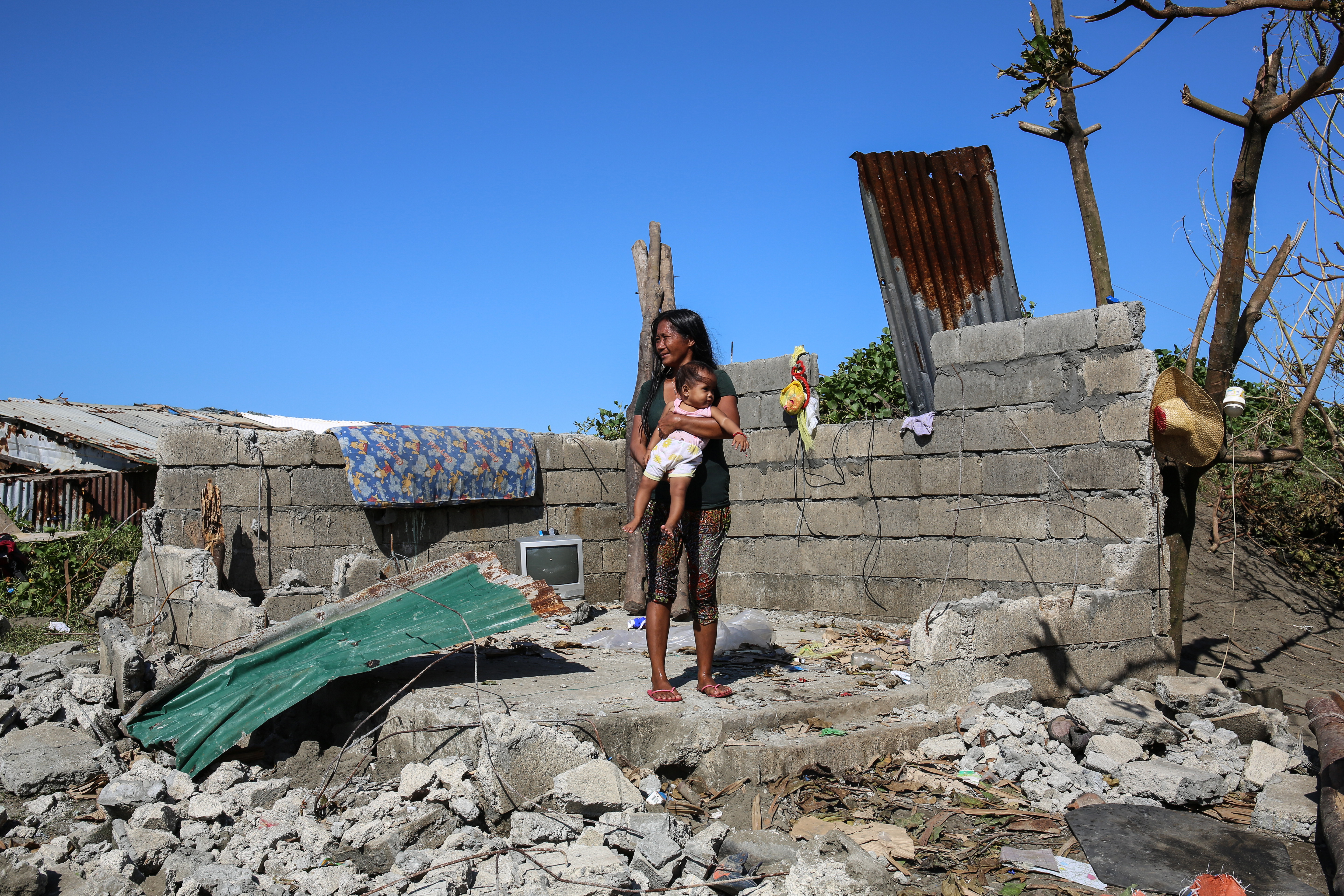 Maya Banadero, 34, stands in her home in Aparri. 