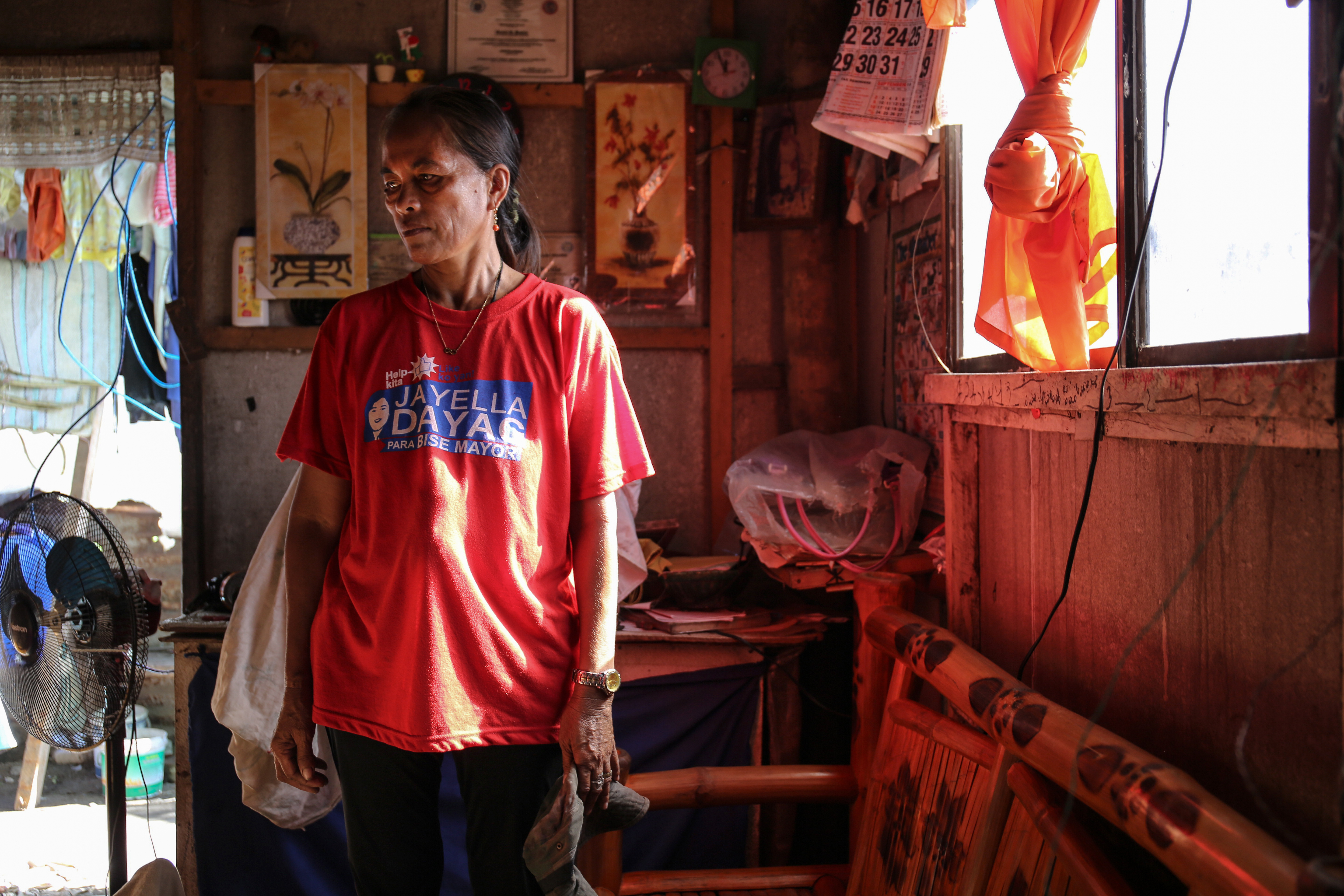 Rowana Basilio, 46, stands inside her home in Aparri. 