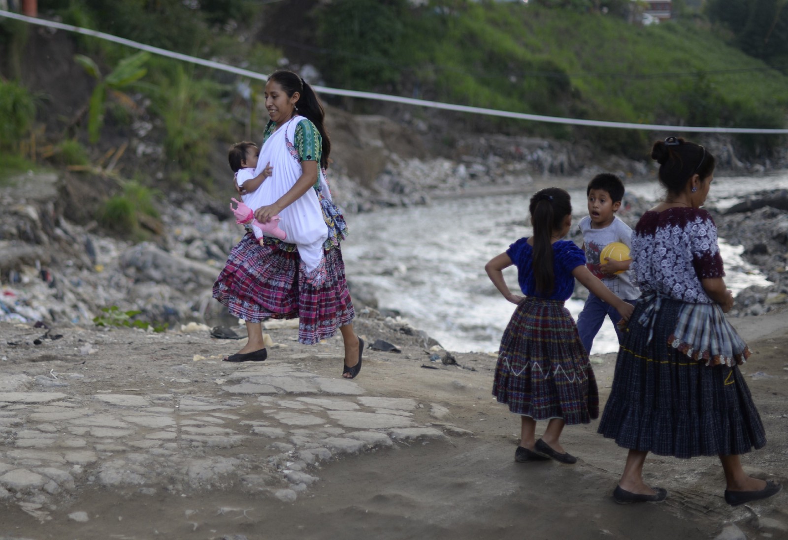 An indigenous woman walks with her baby in Chinautla municipality, 15 kilometers north of Guatemala City, October 25th, 2015.