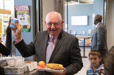 Secretary of Agriculture Sonny Perdue holds up his chocolate milk drink at Discovery Elementary School, in Arlington, Virginia, on October 18th, 2018.