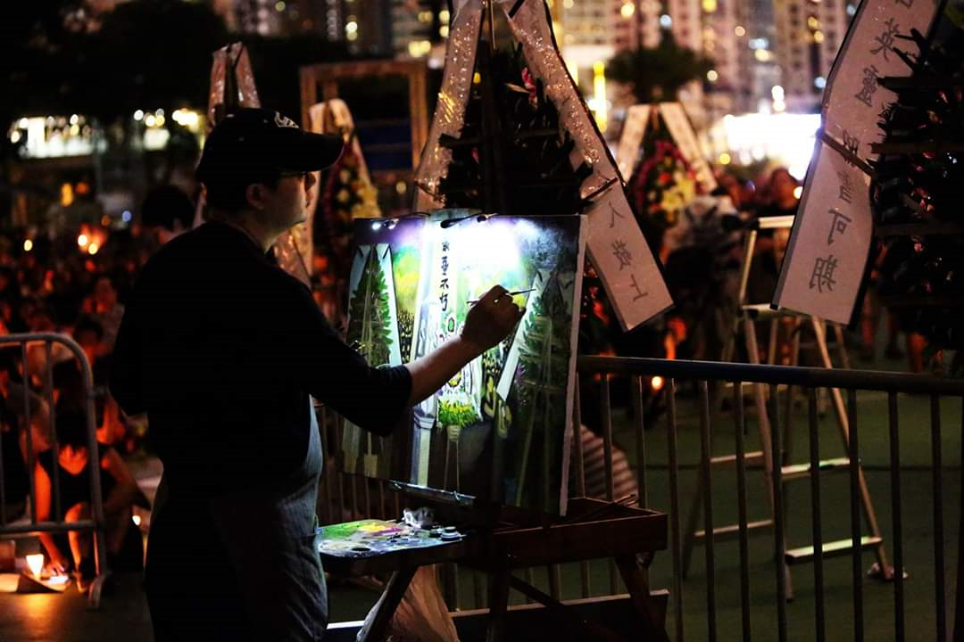 Perry Dino painting in Hong Kong at night.