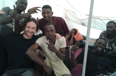 Refugees in the Calais Jungle pose with one of Pearce's friends during a 2016 visit.