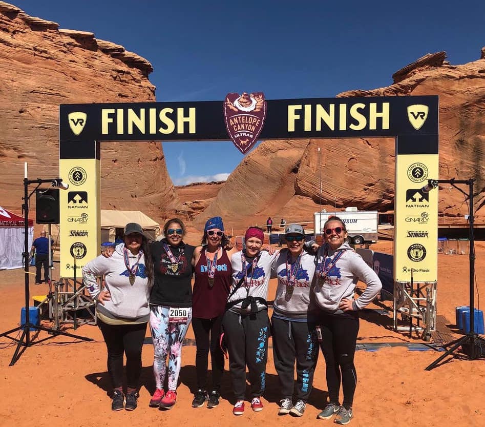 Members of the Kwe Pack celebrating recently at the finish line of the Antelope Canyon Half-Marathon. Left to right: Chally Topping, Sharon Avery, Jen Trotterchaude, Melissa Walls, Alicia Kozlowski Cyr, and Sarah Agaton Howes.