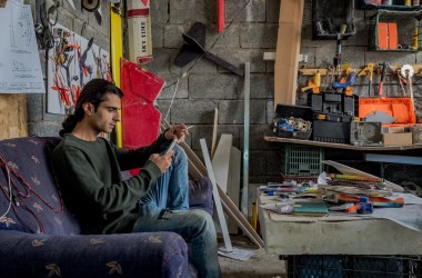 Ari Kamil sits inside his third-floor workshop in Sulaymaniyah, Iraq.