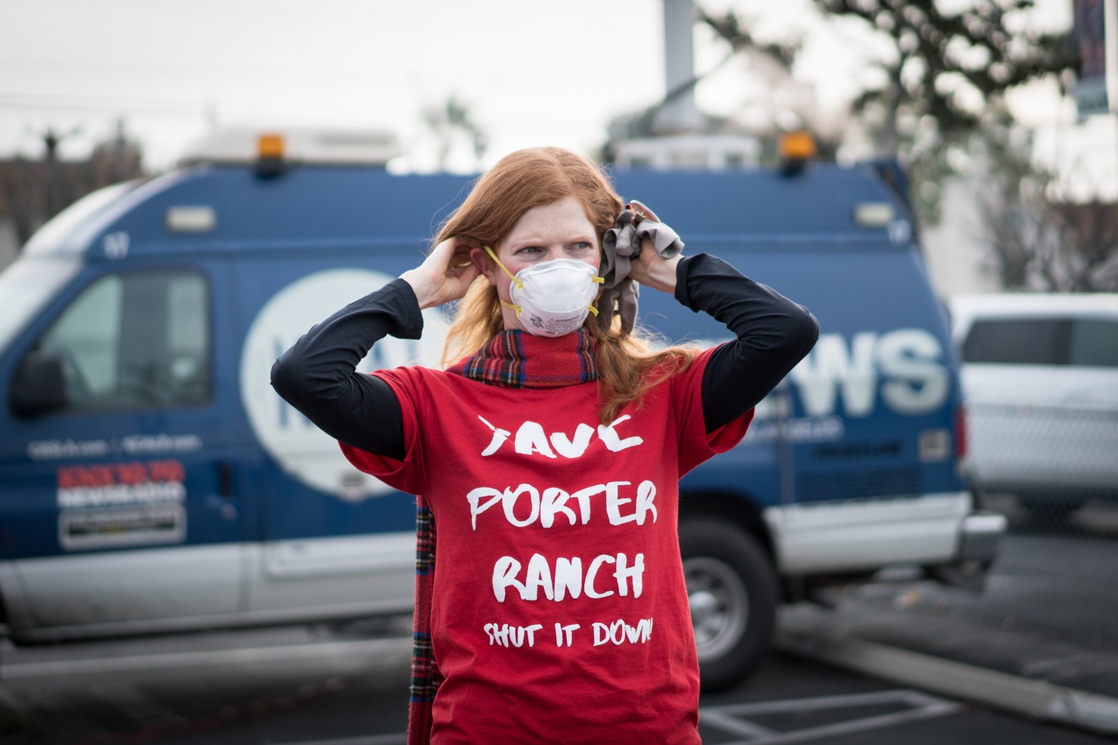 Doctor and activist Leah Garland affixes a gas mask at a rally on January 16th demanding the shut down of the Aliso Canyon oil and gas wells.