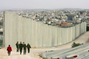 Israeli soldiers patrol in East Jerusalem along the concrete separation barrier bordering Abu Dis, West Bank, in 2006.