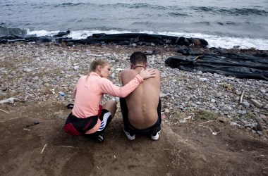 A volunteer tries to console a refugee on Sykamia beach, on the Greek island of Lesbos.