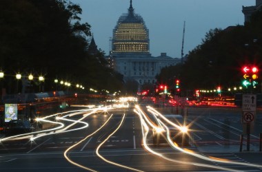 Nighttime photo showing a street approaching the Capitol building