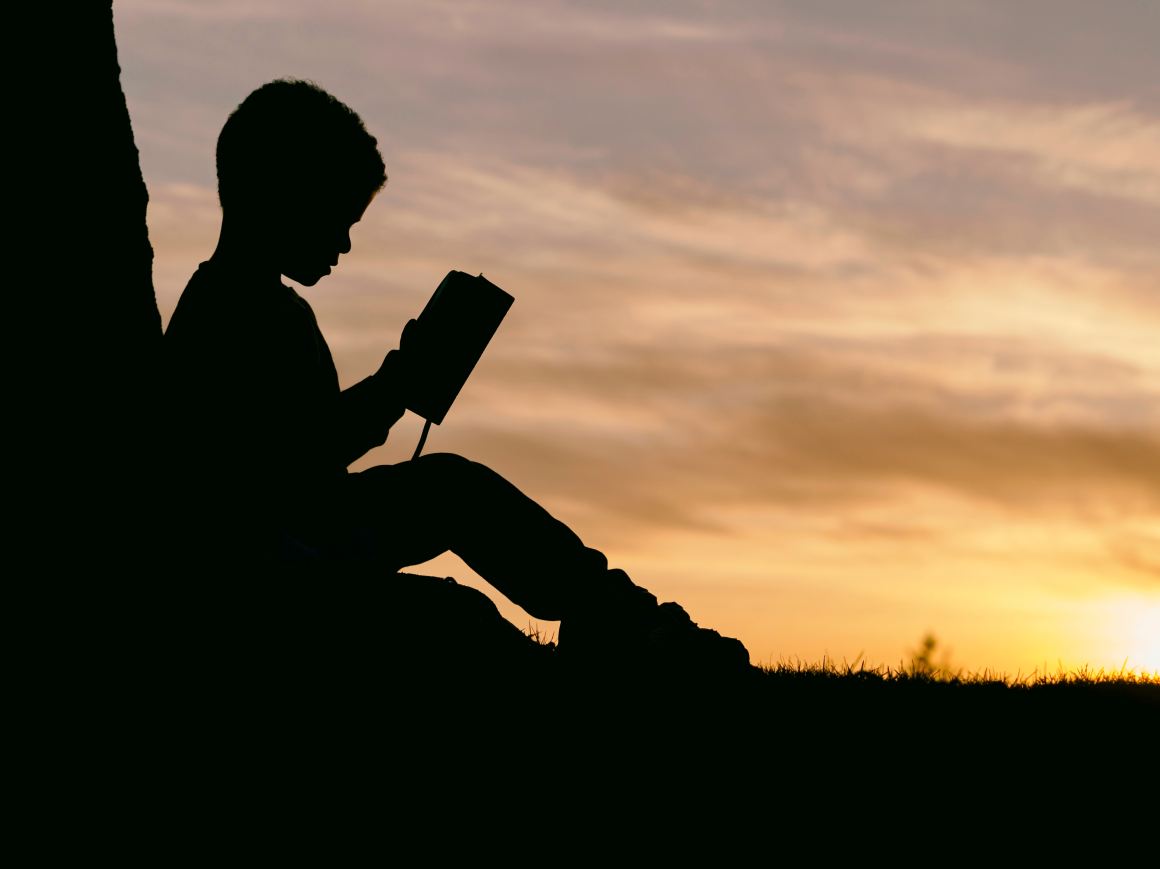 Child reading outdoors nature climate change poetry