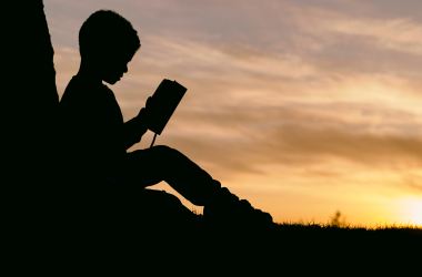 Child reading outdoors nature climate change poetry