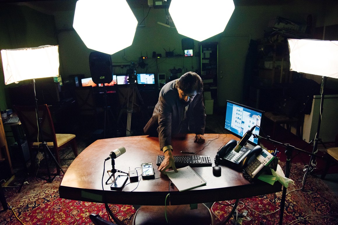 Haroon Ebrat reaches for his notepad, where he has written down audience requests. Ebrat runs Afghan TV, a Farsi-language variety show, out of his garage in suburban California.