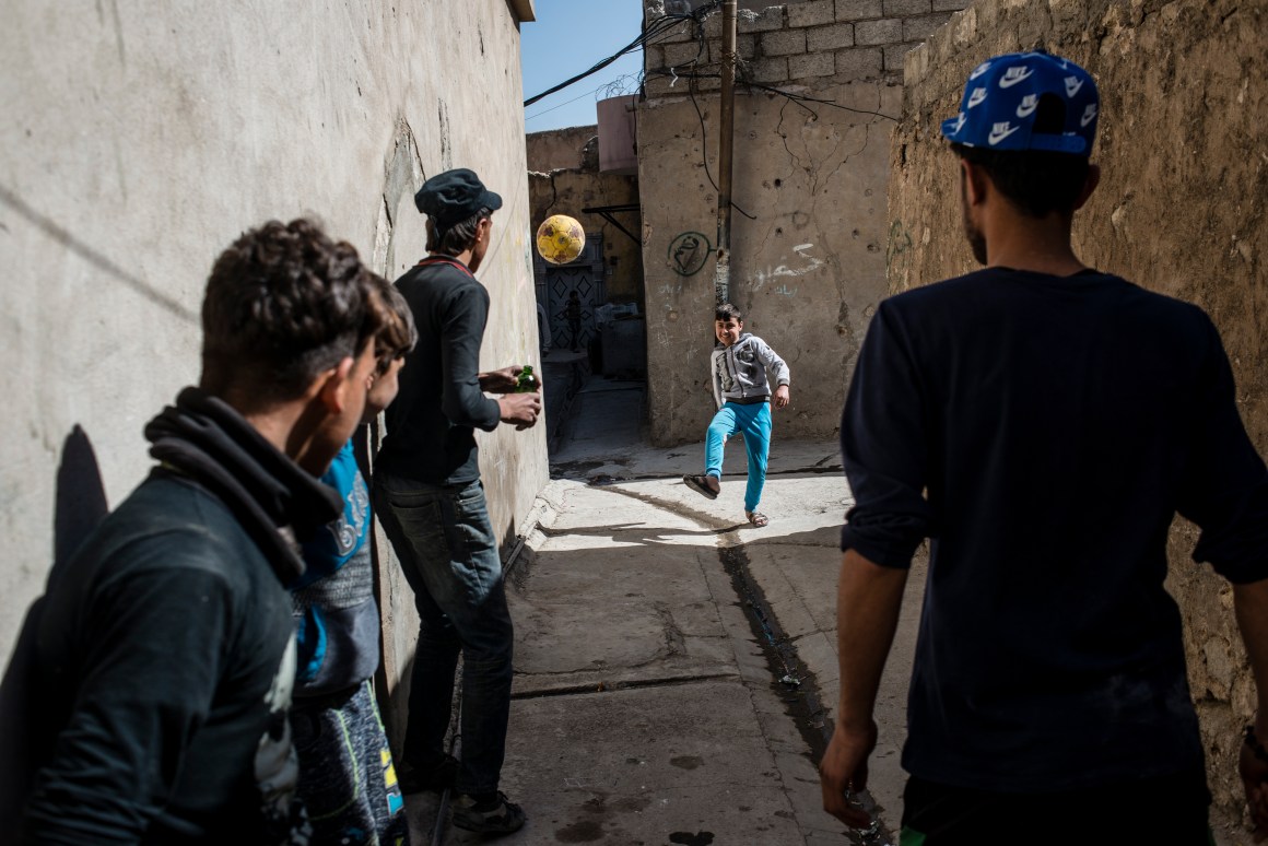 Ali, a boy who lost his arm in a mortar strike while his family was displaced, plays with his friends in the Old City once again.