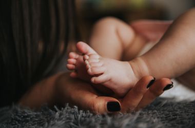 Mother holding baby's feet