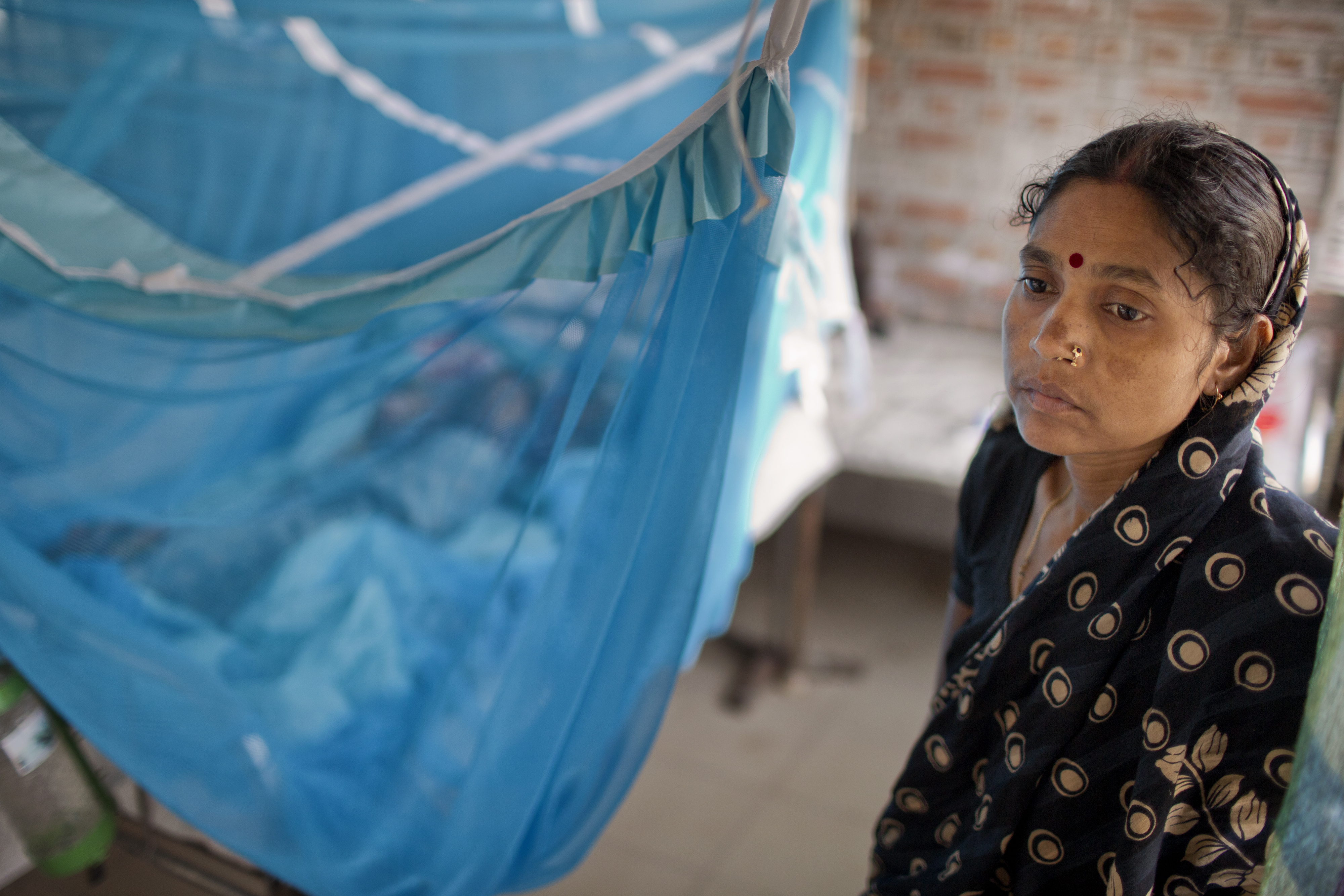 A young mother stands watch over her son who was admitted at Faridpur Medical College Hospital with symptoms of encephalitis. Diagnostic tests later determined that Nipah virus was not the cause of his illness.