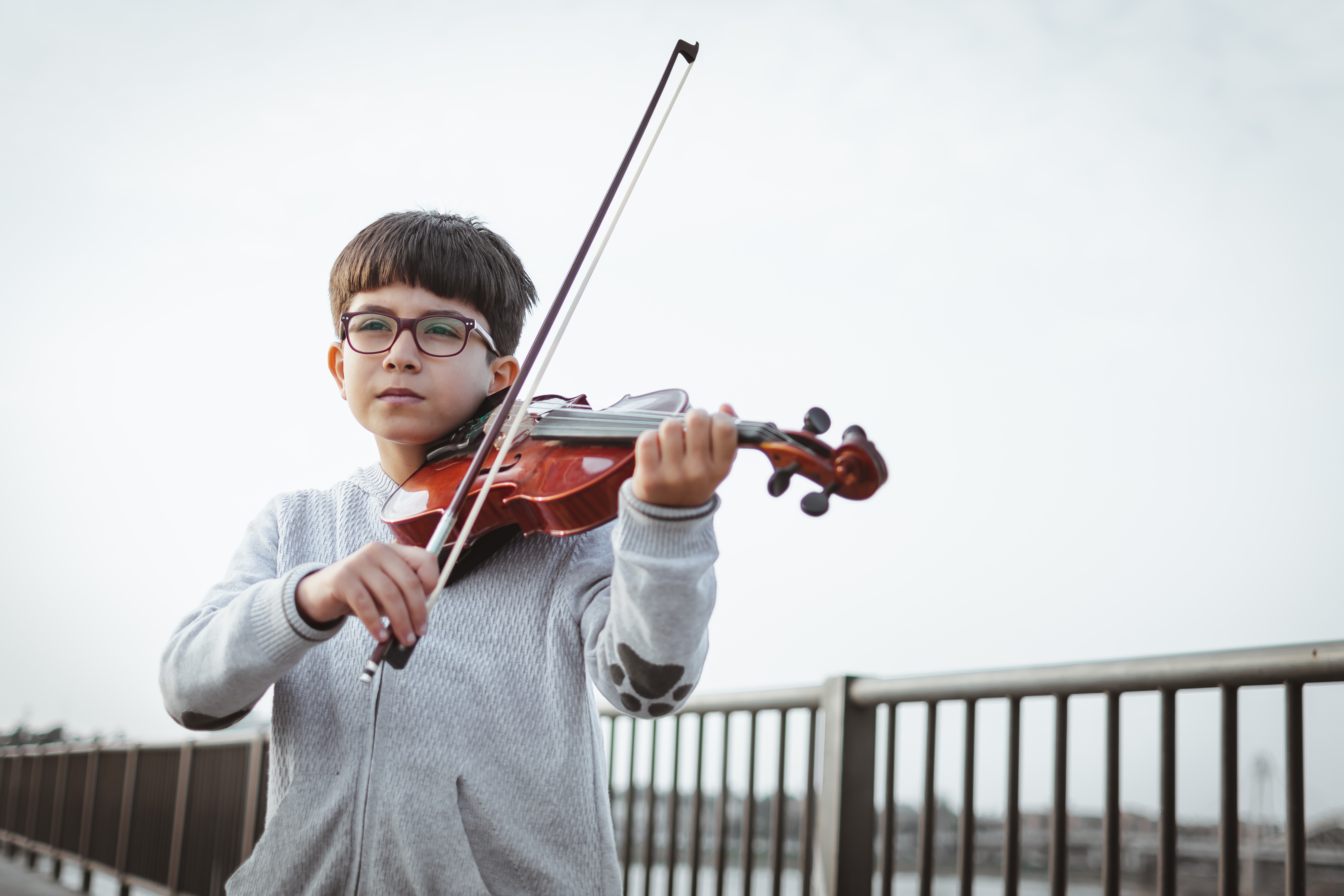 Boy playing violin child music education