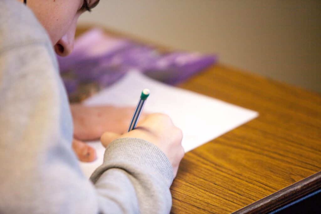 Woman girl taking standardized test school classroom