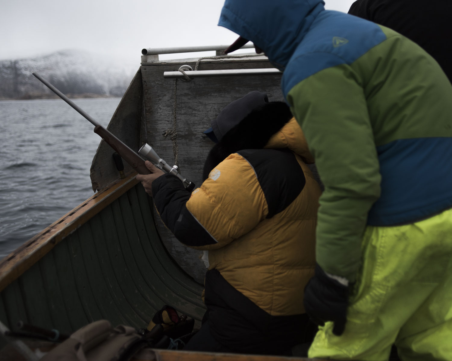 Markoosi Illauq (right), 15, points out a seal while his uncle takes aim.