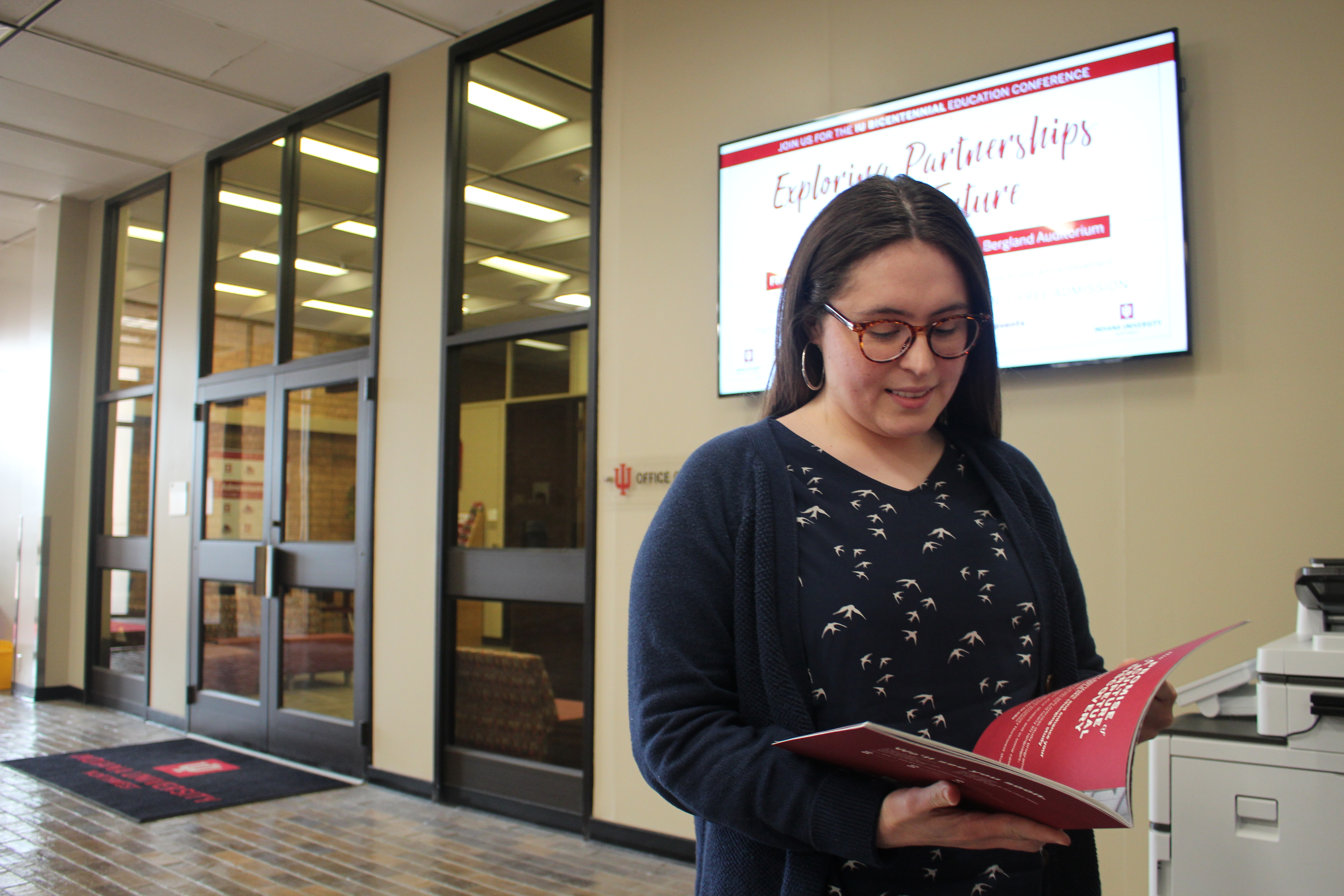 Ruby Ortiz flips through a brochure in Hawthorn Hall.