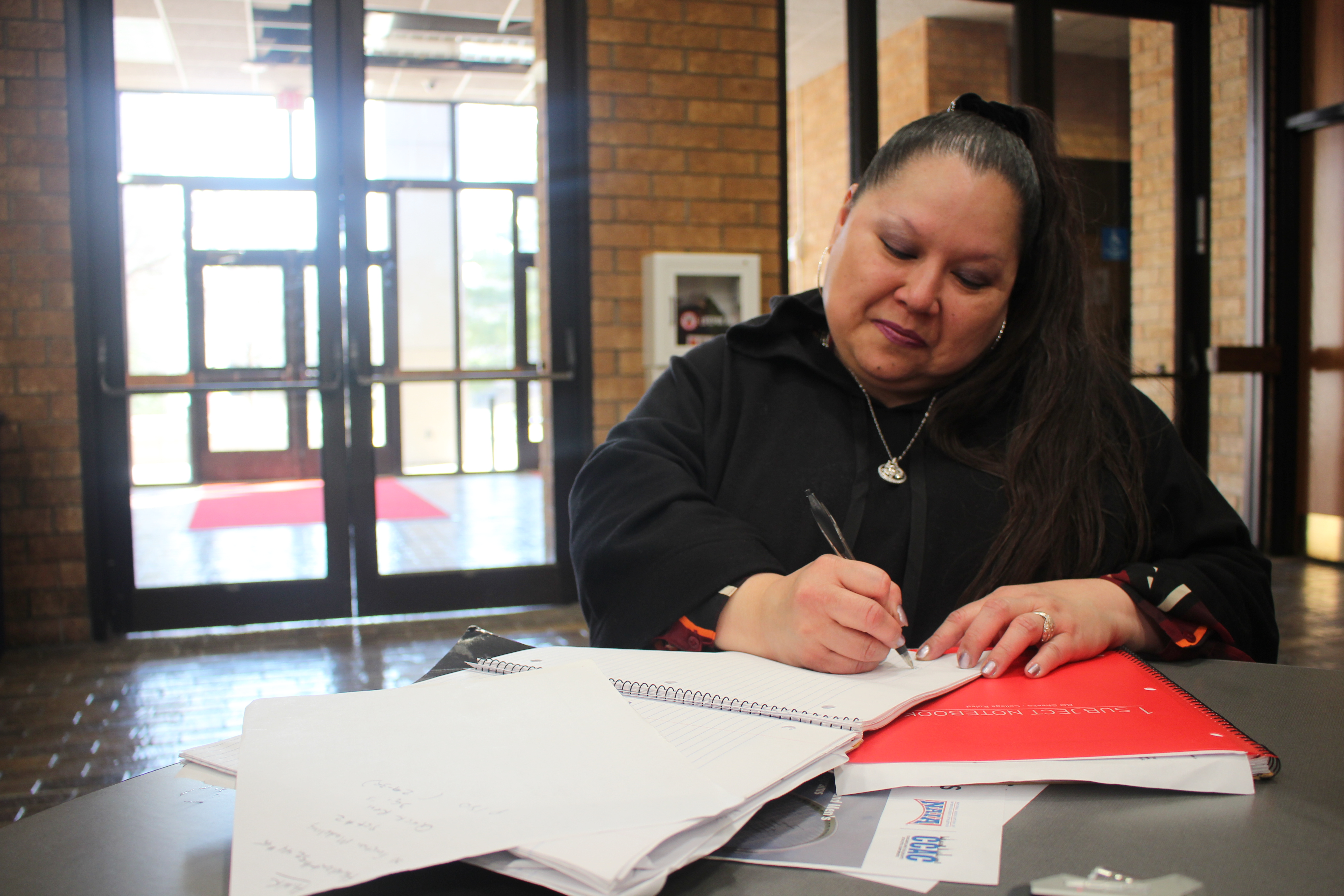 Hsiulien Perez jots down notes in Hawthorn Hall just before heading to an afternoon class.