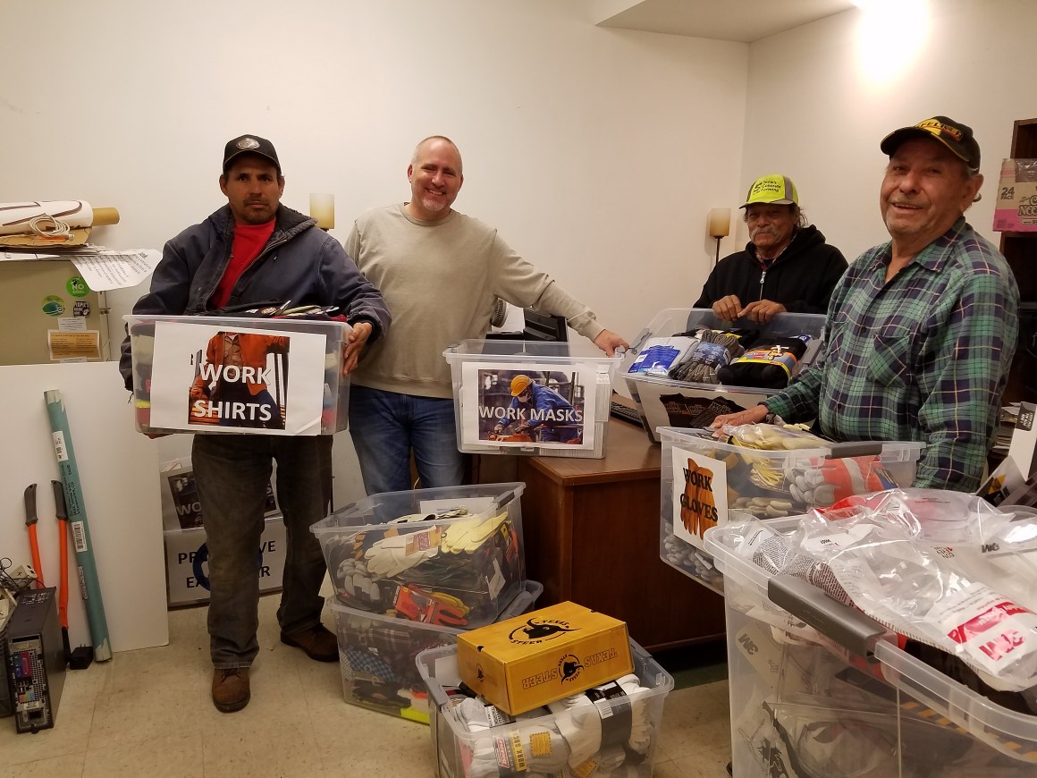 People gather together work supplies at Centro Humanitario in Denver, Colorado.