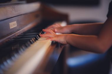 Child playing piano music arts education