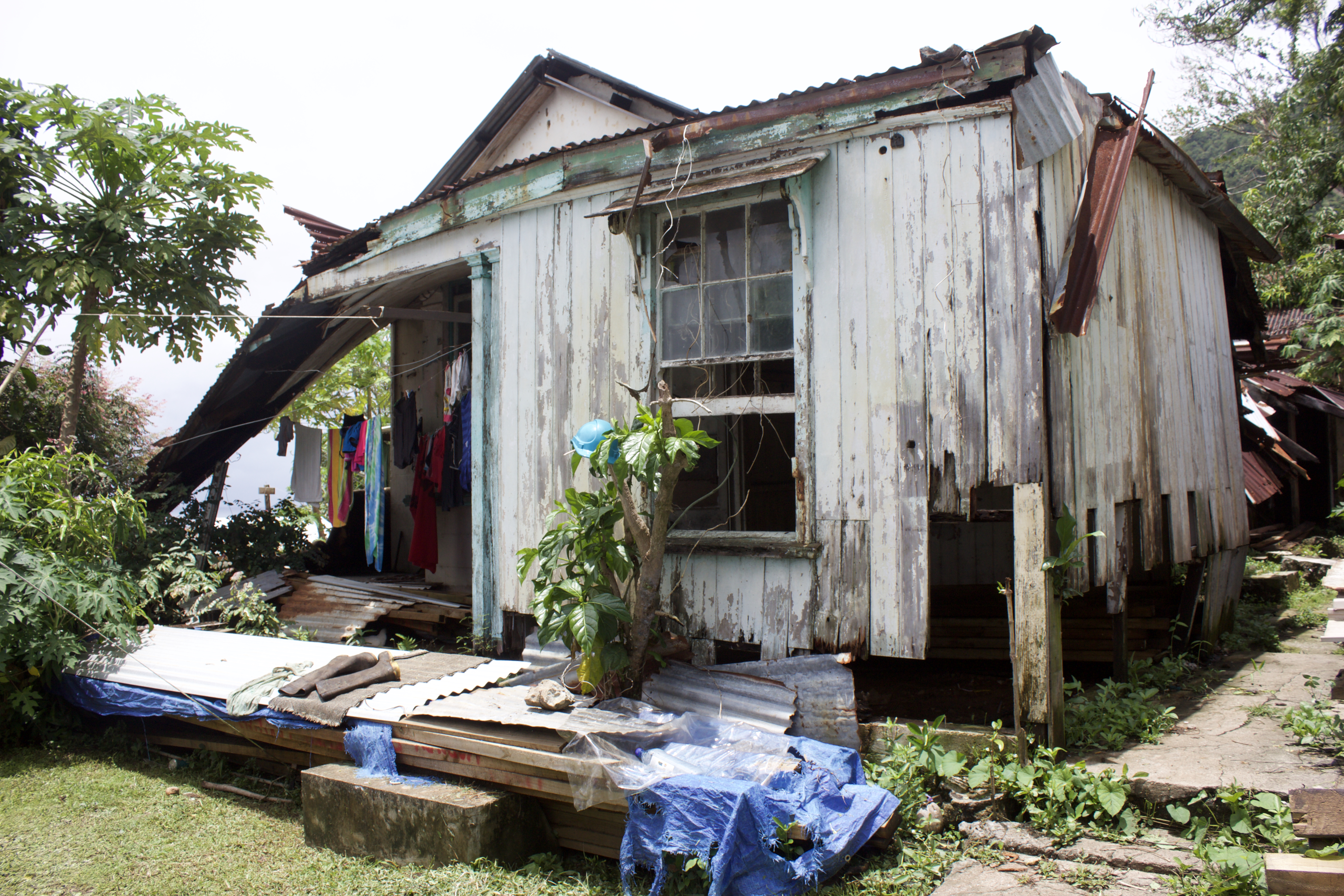 Flora's former house, which collapsed during Cyclone Winston. When it rains, the families hang clothes to dry under the remaining roof because there's no room in the tents.