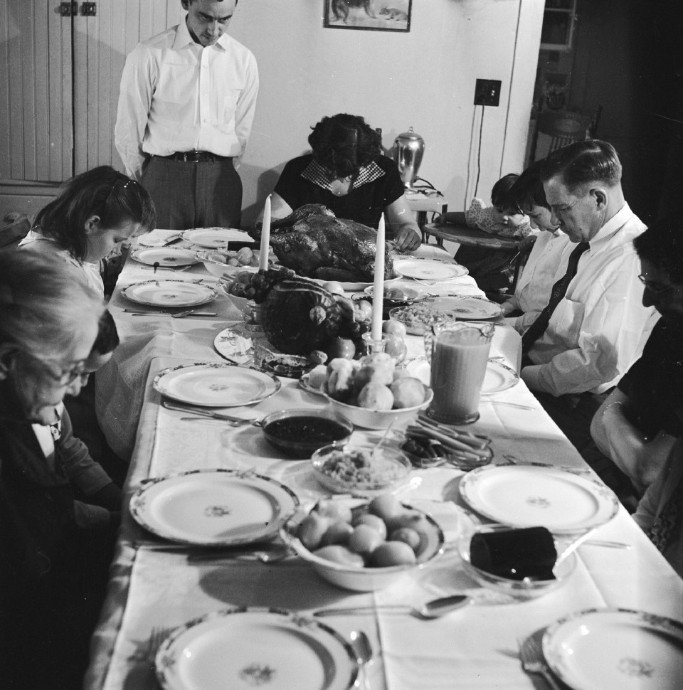 An American family saying pre-Thanksgiving grace, circa 1955.