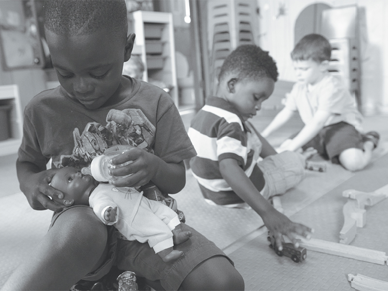 Five-year-old Ian plays with a doll.