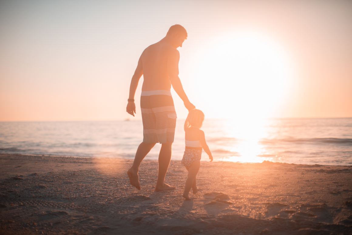 father son on beach parenthood children family