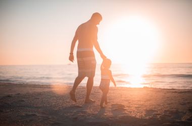 father son on beach parenthood children family