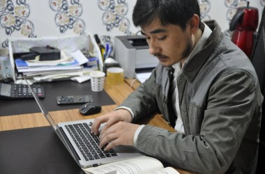 Ershat Bahtiyar, 27, digitizes an older volume by typing it directly into a word document. This one, he says, will take two days to complete.