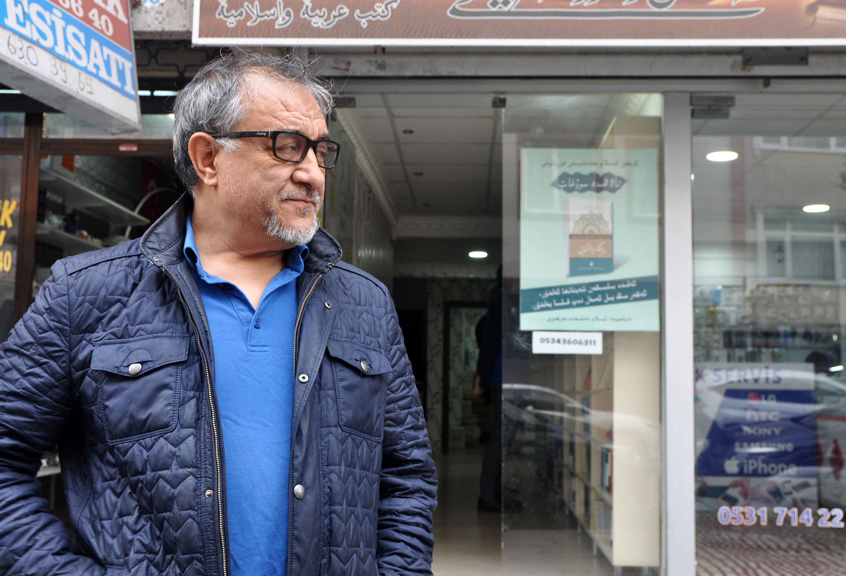 Abduljelil Turan, 60, stands outside his Uyghur-language publishing house and bookstore in Istanbul.