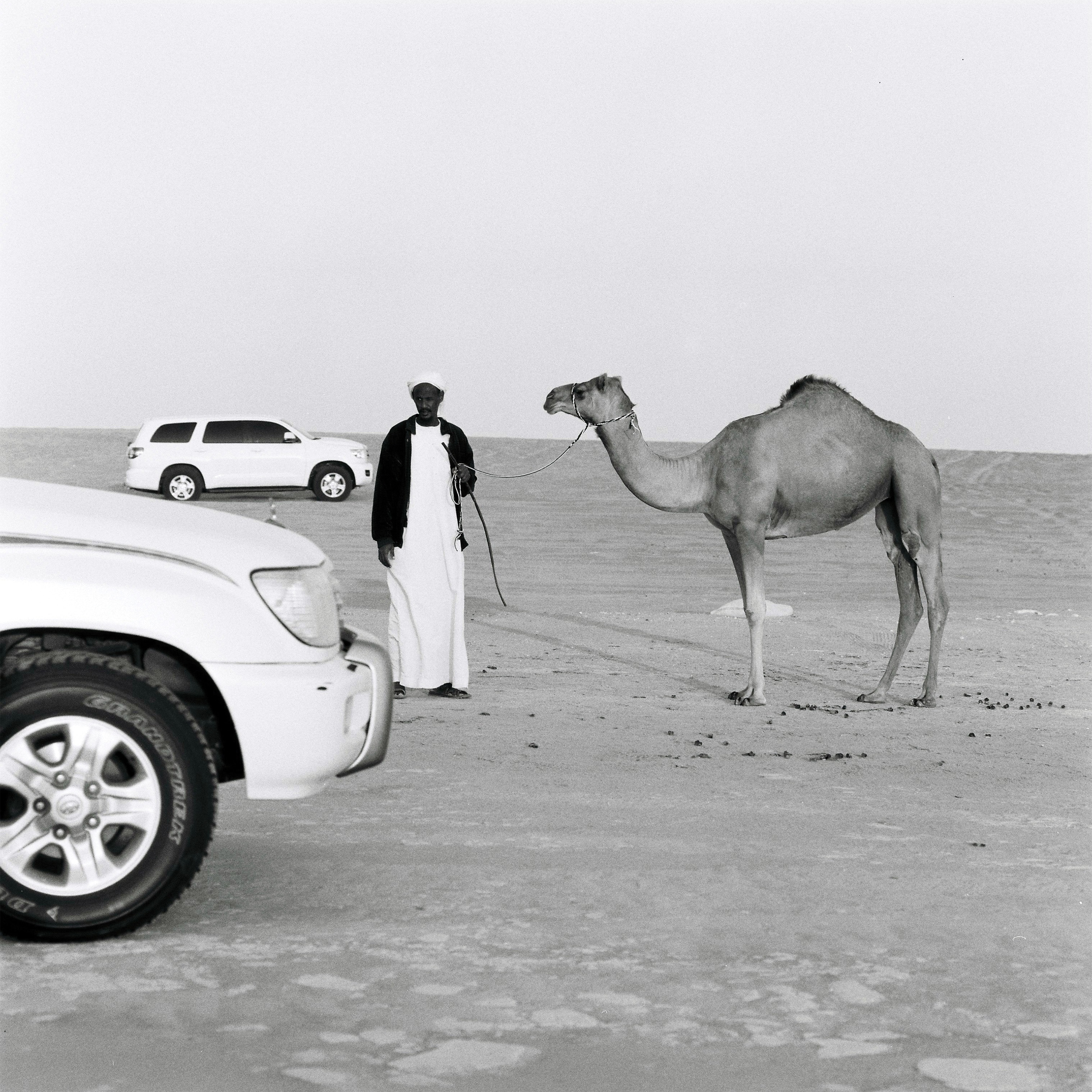 A Sudanese camel trader in the Rub' al-Khali desert in the United Arab Emirates, where the animals sell for thousands of dollars and camel beauty pageants are a regular occurrence.