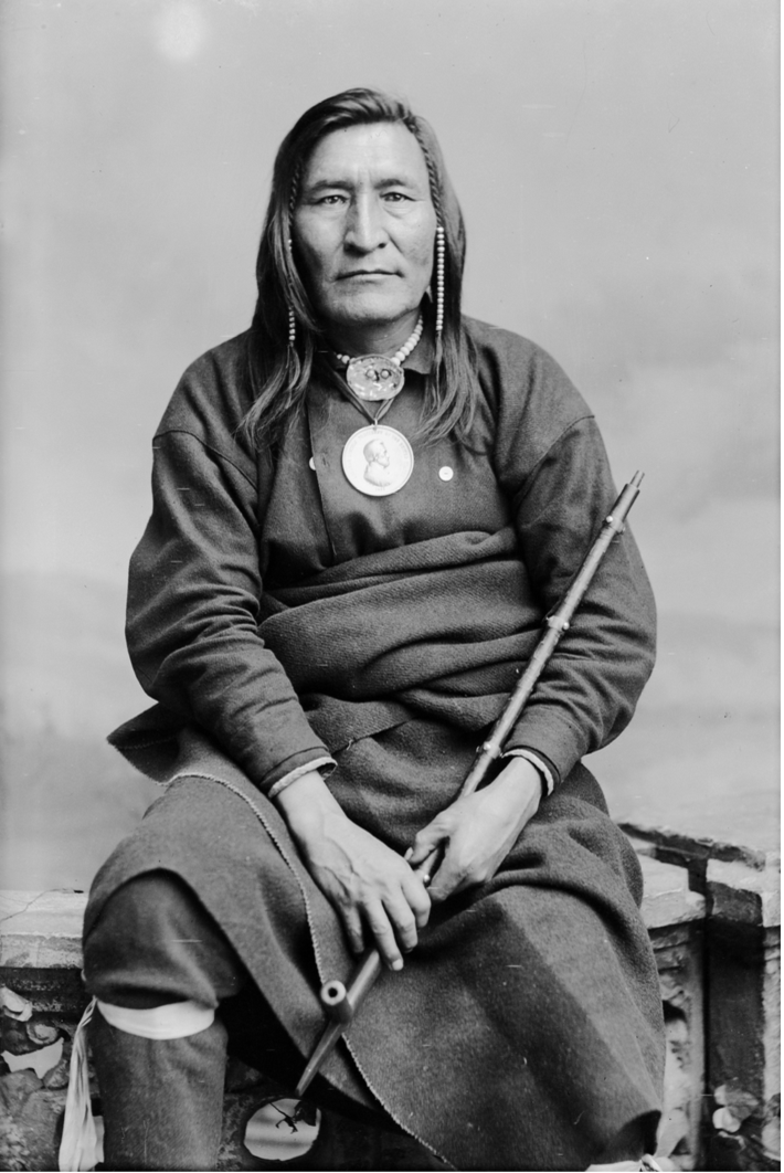 Chief Little Shell in Partial Native Dress with Abraham Lincoln Peace Medal and Ornaments and Holding Pipe, circa 1880.