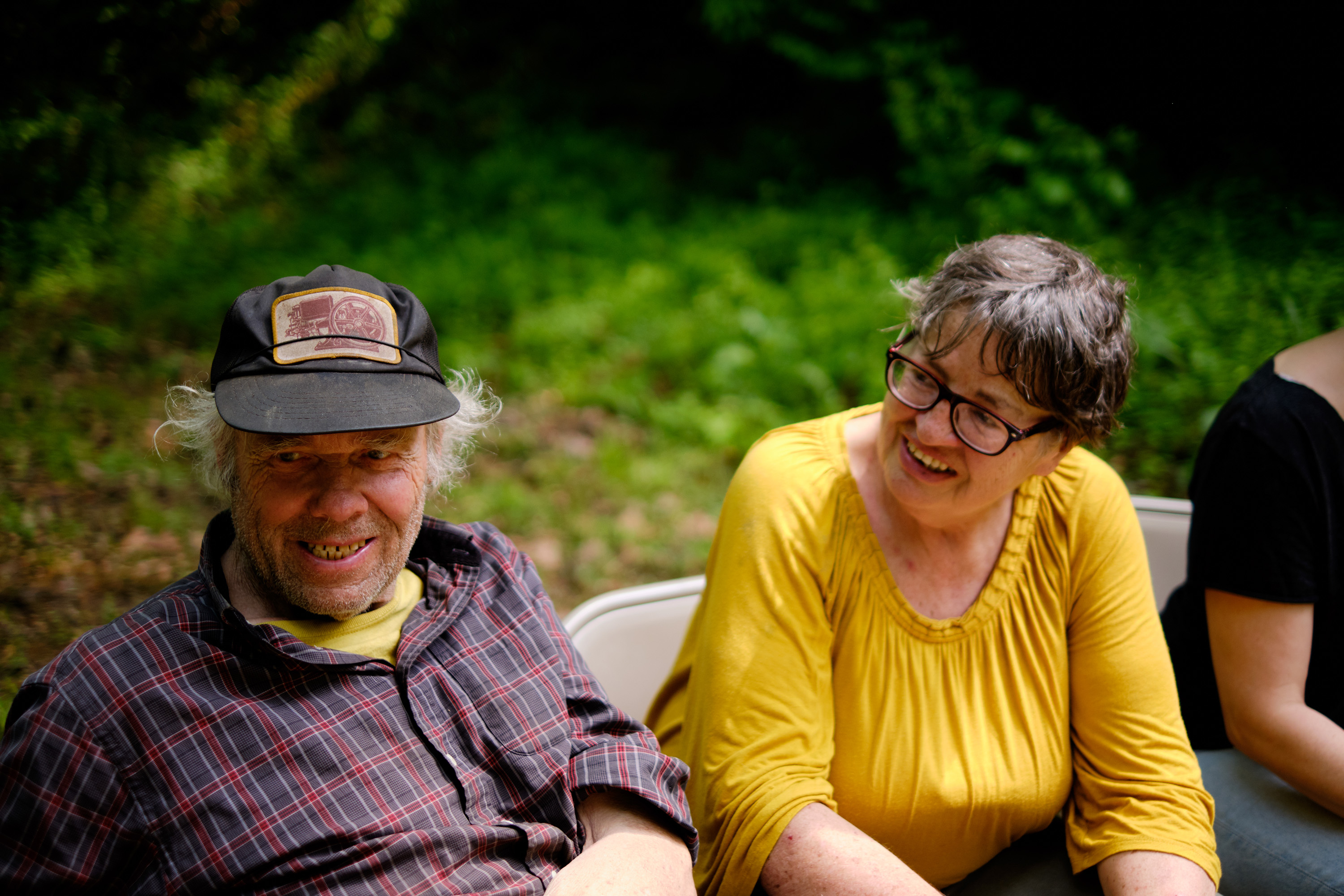 Roger Blosser, seated next to wife Cheryl Blosser, during the discussion portion of a Forest Listening Room at Robinson's Cave in Wayne National Forest in May. Roger worked as an oil driller in Southeast Ohio for more than 50 years, and before that he worked in the coal mines as a teen. His father used to make moonshine in New Straitsville, home of the Moonshine Festival.