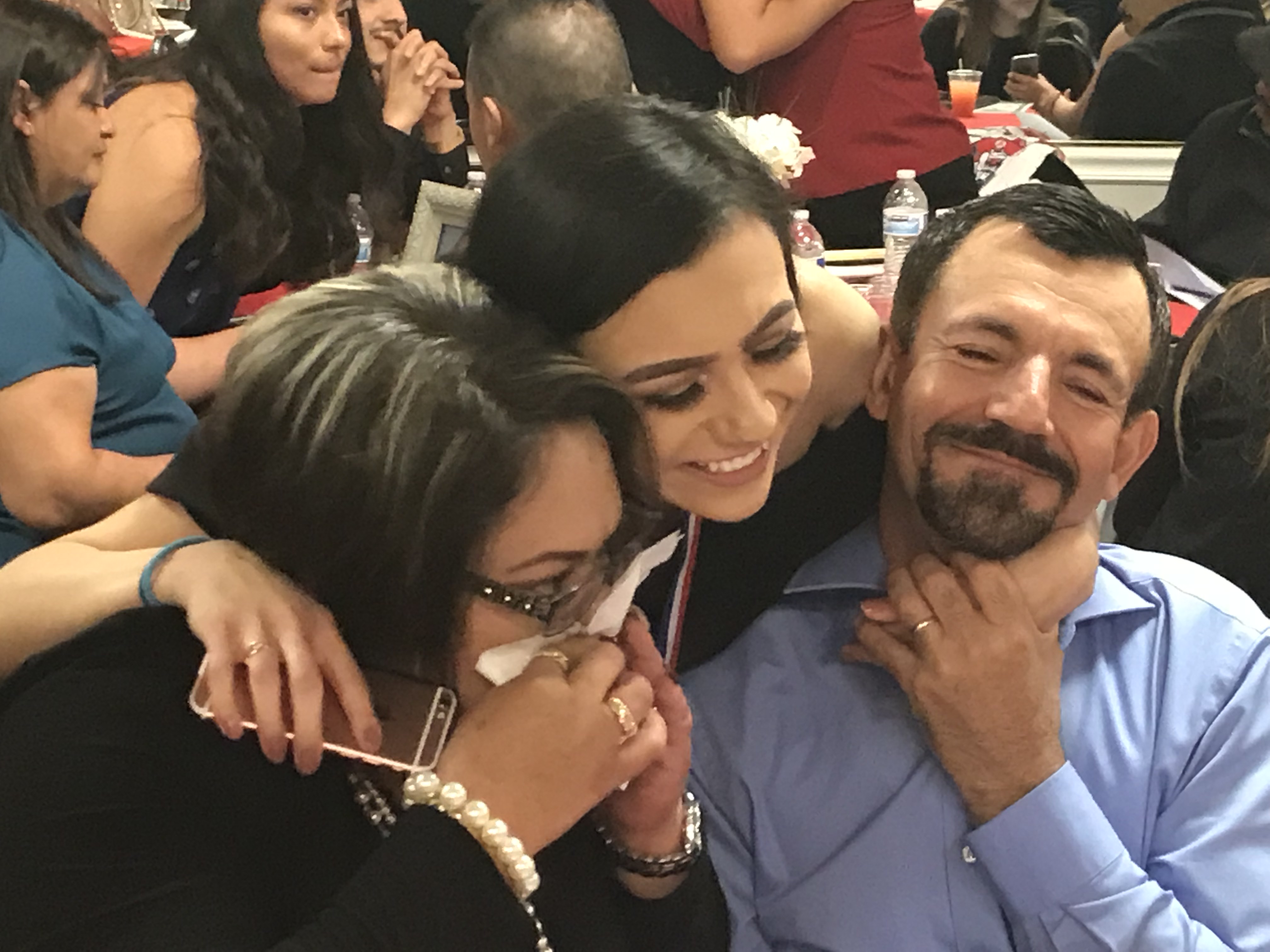 Julia Gomez-Delgado hugs her parents.