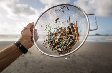 A volunteer of the non-governmental organization Canarias Libre de Plasticos carries out a collection of microplastics and mesoplastic debris to clean the Almaciga Beach, on the north coast of the Canary Island of Tenerife, on July 14th, 2018.