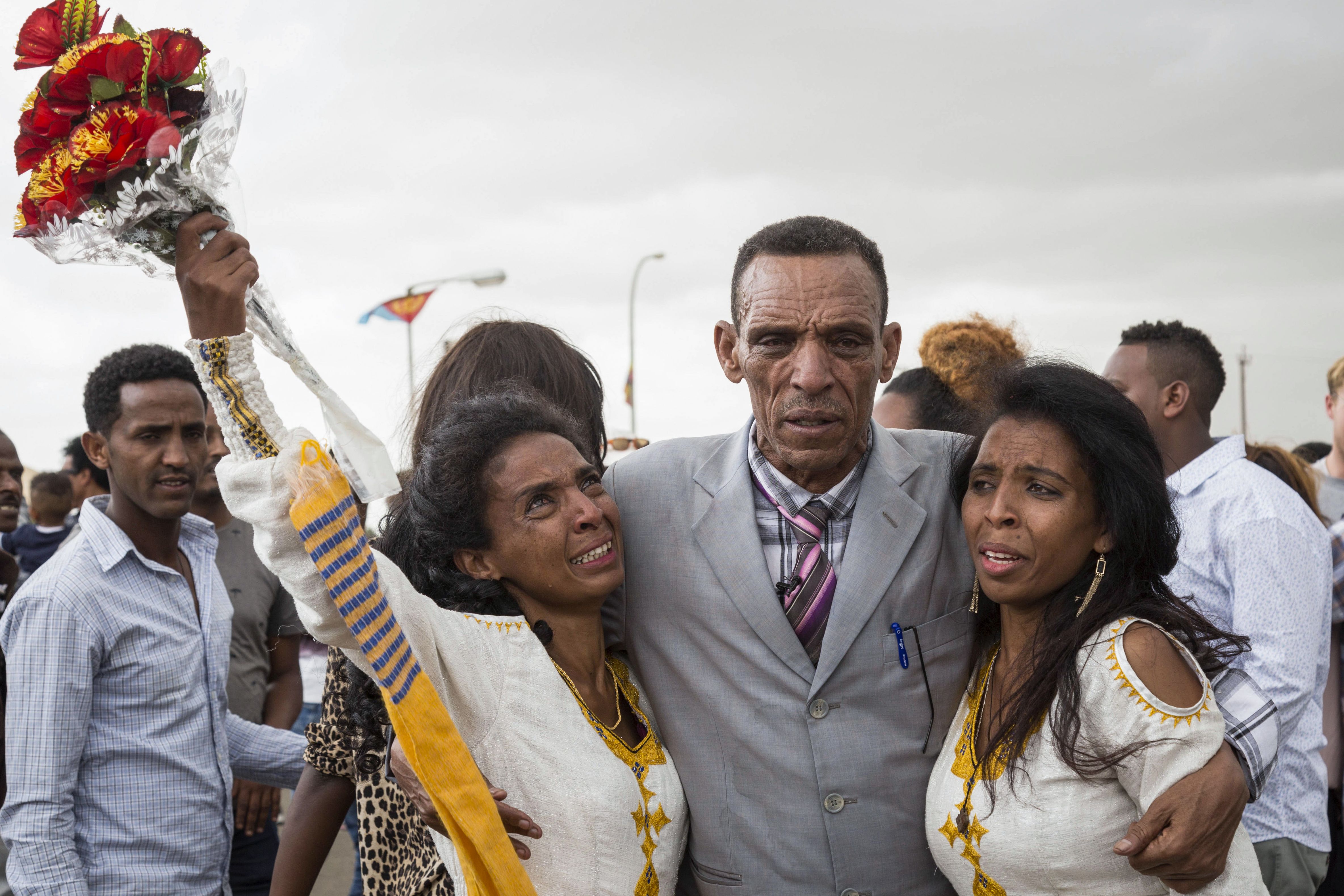 Azmera Addisalem and Danait Addisalem greet their father, an Ethiopian journalist, for the first time in 20 years, upon his arrival at the Asmara International Airport on July 18th, 2018.