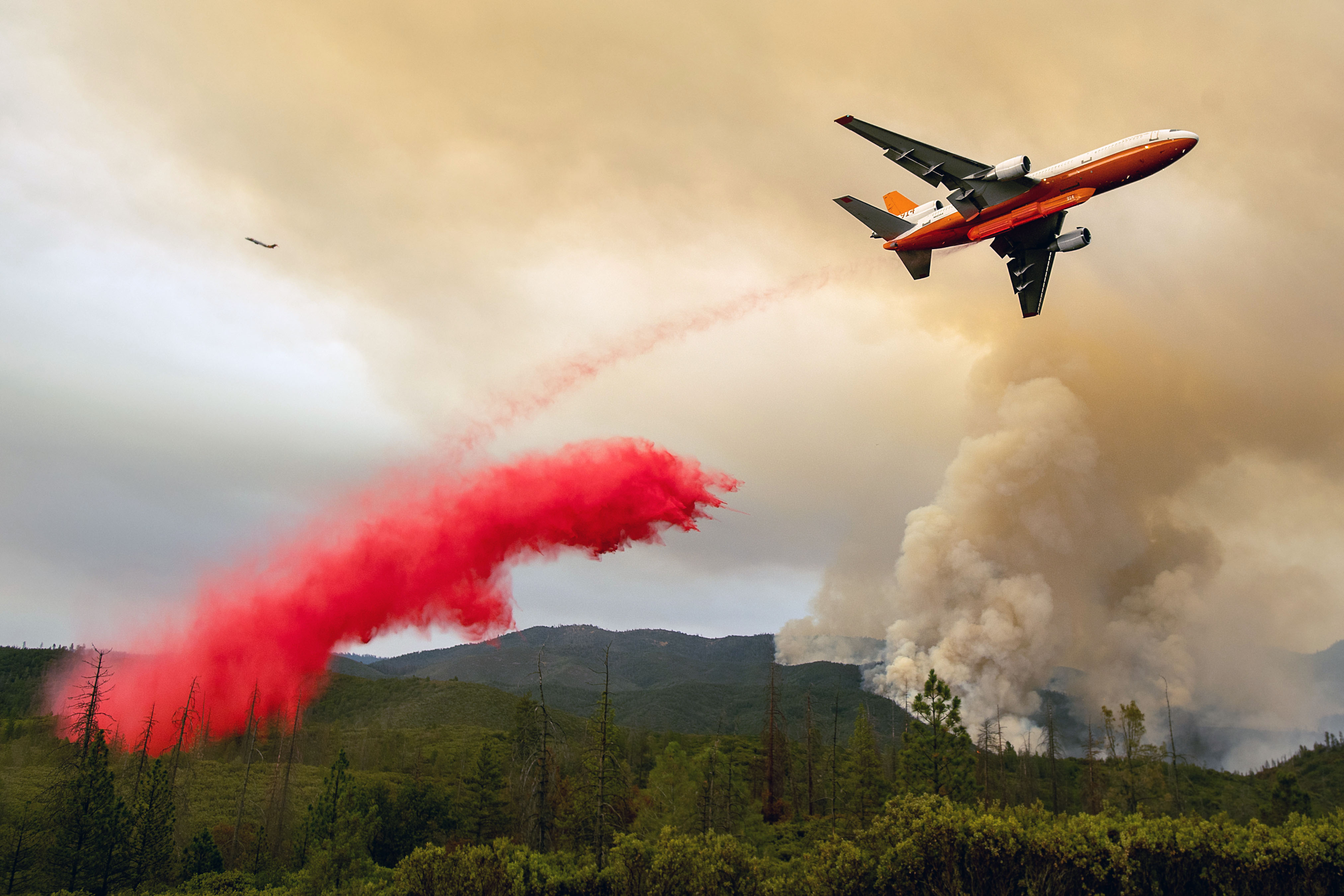 An air tanker drops retardant while battling the Ferguson Fire in the Stanislaus National Forest, near Yosemite National Park, on July 21st, 2018.