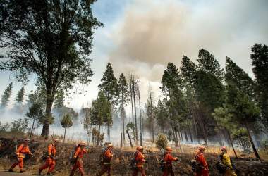 Inmate firefighters battle the Ferguson fire in Jerseydale, California, on July 22nd, 2018. A fire that claimed the life of one firefighter and injured two others near California's Yosemite National Park has almost doubled in size in three days, authorities said Friday. The U.S. Department of Agriculture said the so-called Ferguson fire had spread to an area of 22,892 acres, and was so far only 7 percent contained.