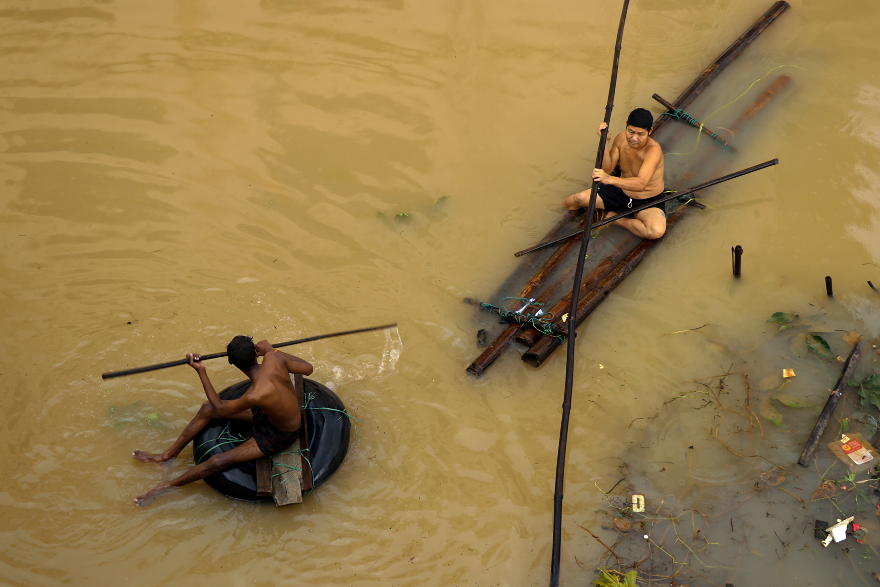 Residents use improvised rafts to move through floodwaters in Hpa-an, Karen state, on July 28th, 2018. Floodwaters have forced thousands from their homes in southeast Myanmar.