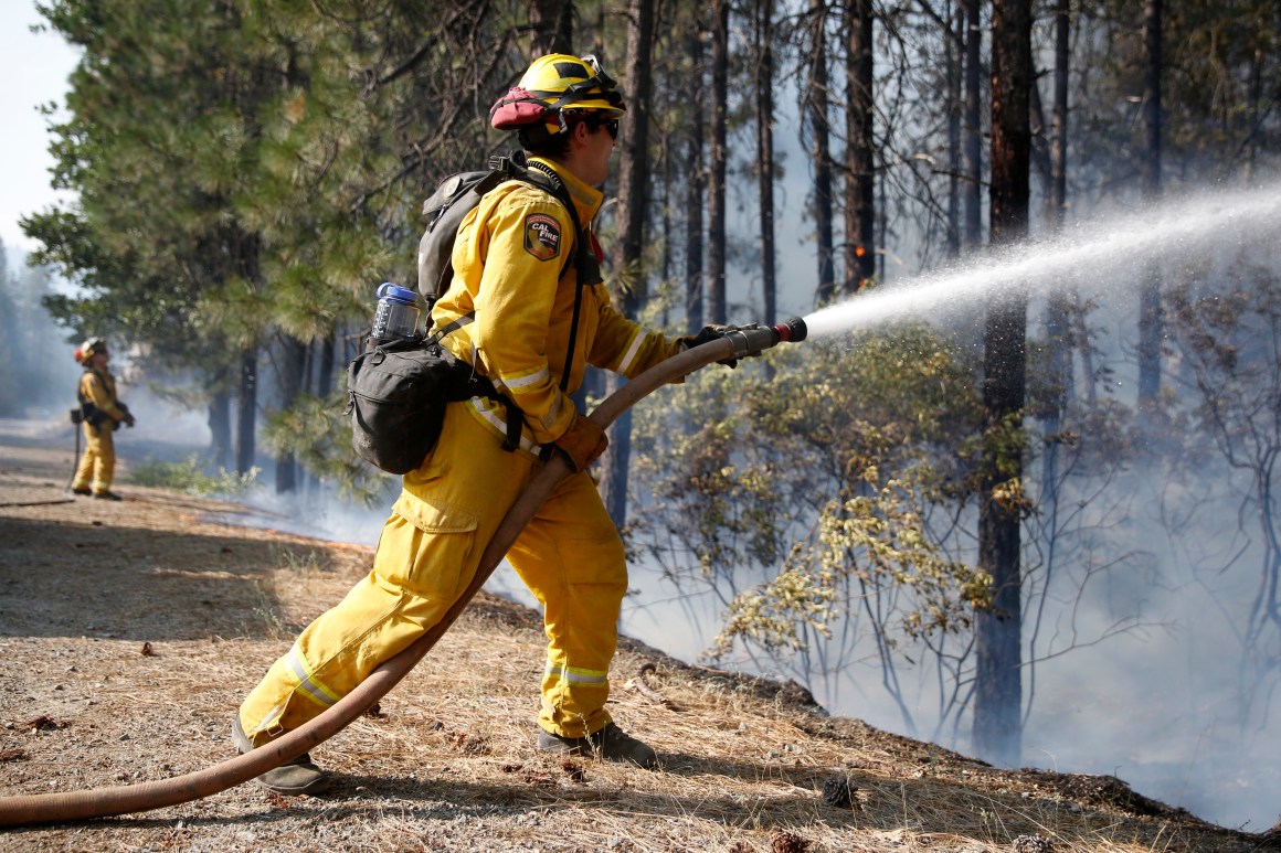 A firefighter extinguishes flames while battling the Carr fire on July 30th, 2018, near Redding, California.