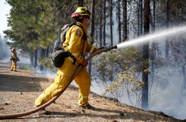 A firefighter extinguishes flames while battling the Carr fire on July 30th, 2018, near Redding, California.